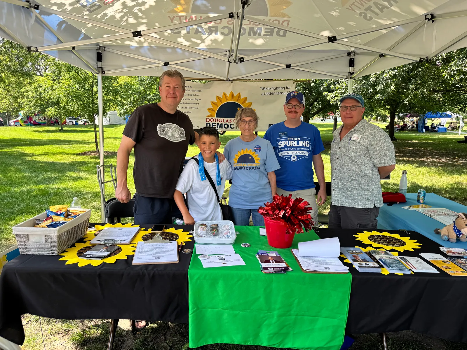Volunteers and supporters gathered at a Juneteenth outreach table in Lawrence, Kansas.