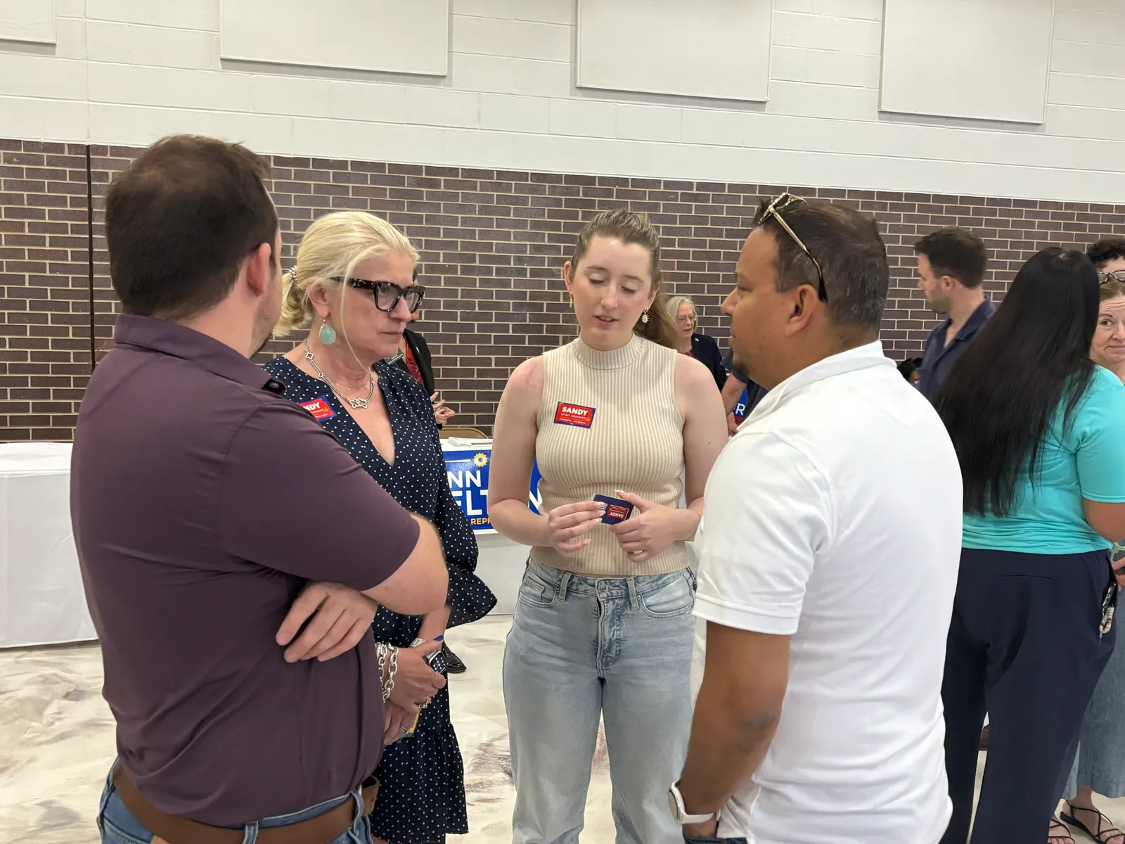 Juan C. Luengo talks with residents at a Wyandotte County campaign event.